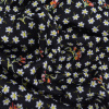 Miniatura de foto de Punto neopreno negro florecillas blancas y amarillas